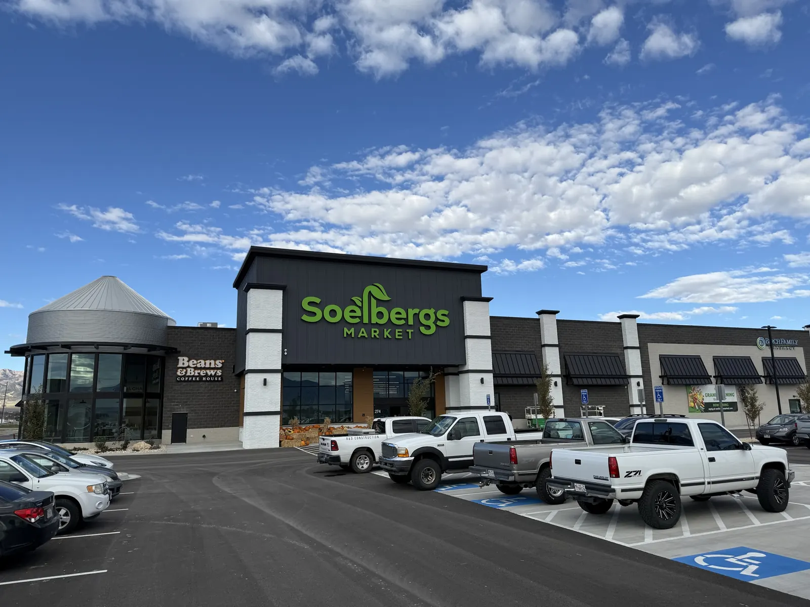 Soelbergs Market beside a metal silo and the Beans & Brews Coffee House