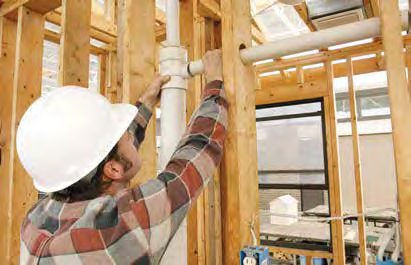 Plumber working on new-build rough-in