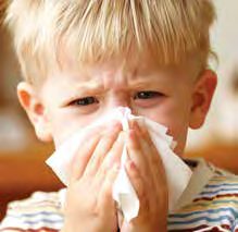 Child with allergies blowing nose