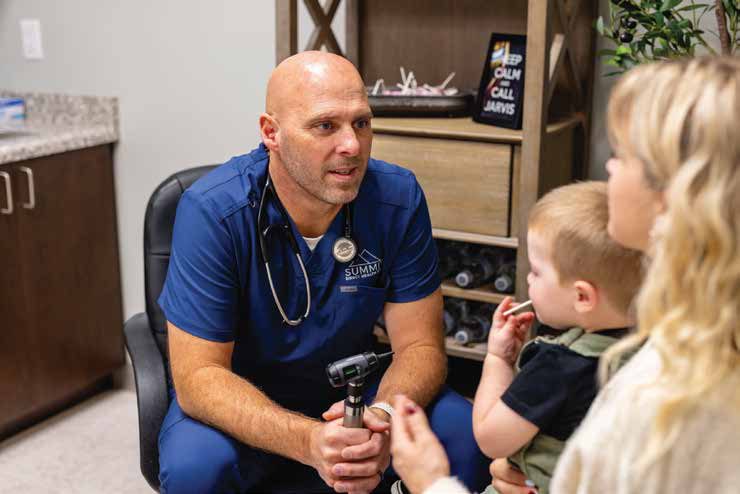 Chad Jarvis, PA-C, with a young patient