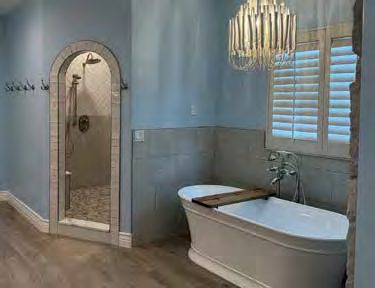 Remodeled bathroom with freestanding tub by Terry George Construction